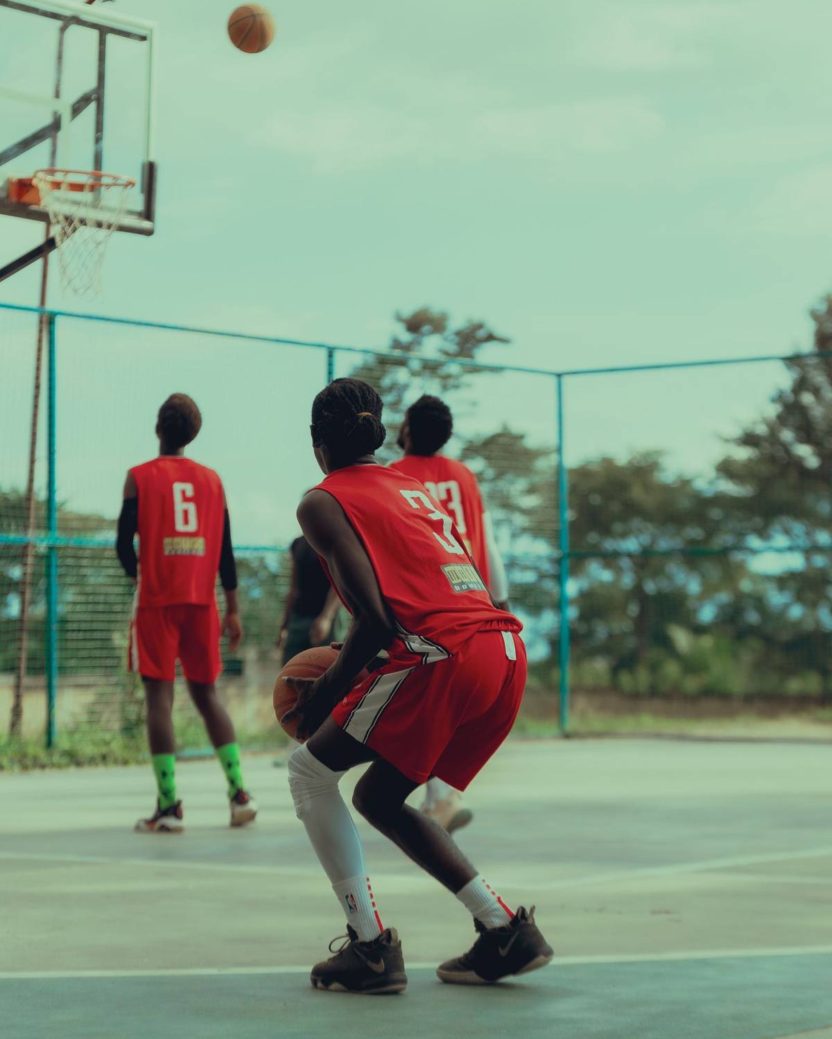 Young basketball players scrimmaging on court