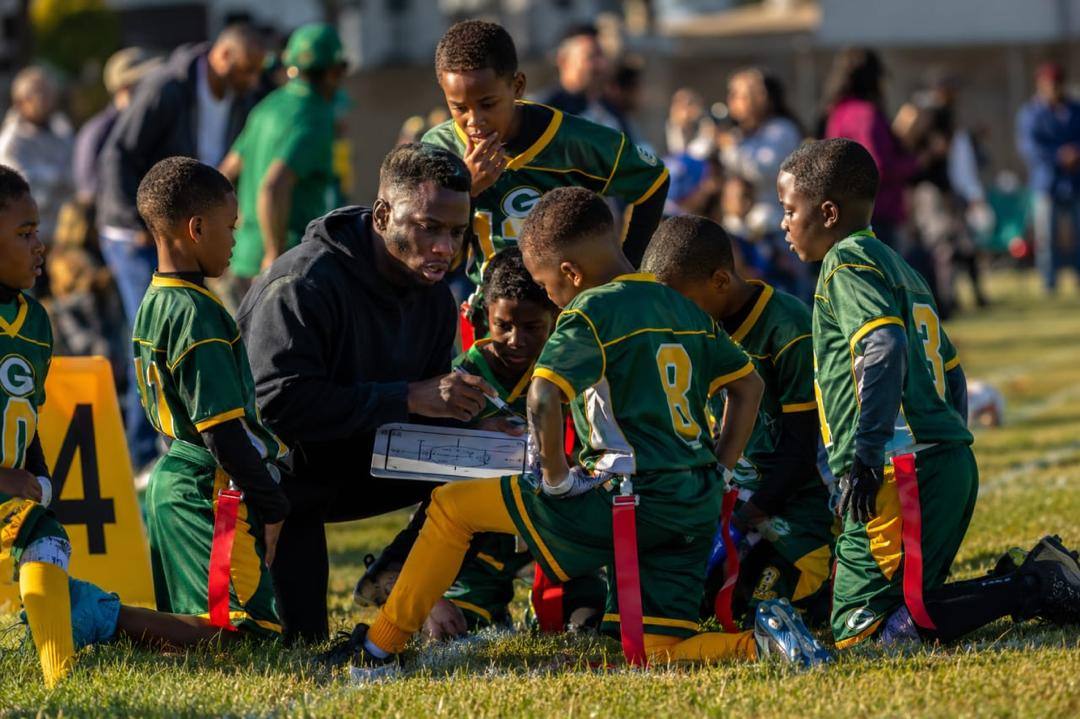Coach reviewing a play with a flag football team