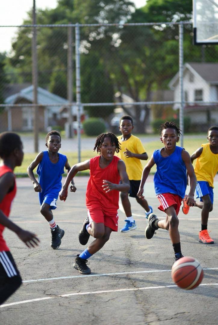 Kids chasing after the ball during a scrimmage