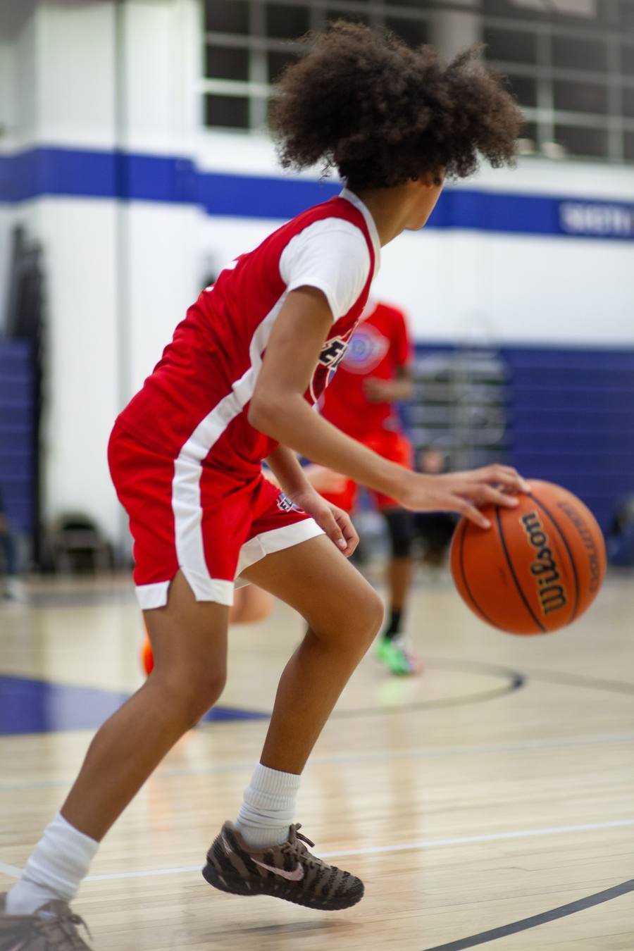 Young athlete dribbling in an indoor gym
