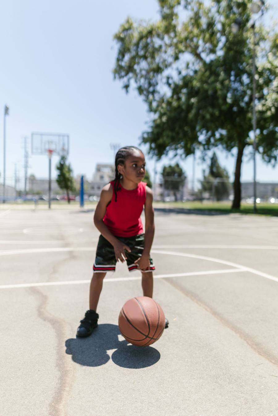 Young athlete dribbling on an outdoor court
